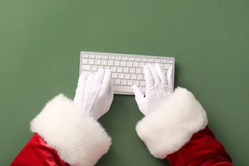 Fotobehang Muziek Santa Claus hands with keyboard on green background  © Pixel-Shot