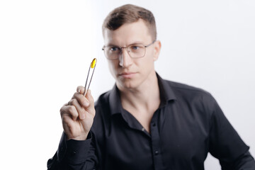 Quality in production pharmacology facility, Medical nutritionist examining omega fish oil yellow capsules in laboratory, blue light