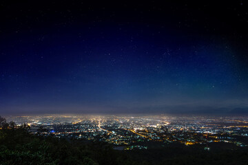 full moon over Chiang mai city at night, aerial view City night from the view point on top of mountain 