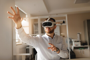 Young caucasian male worker exploring virtual reality with headset in office setting, ai assistant video call concept