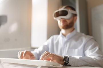 Young caucasian male using vr headset in modern office setting, sunlight