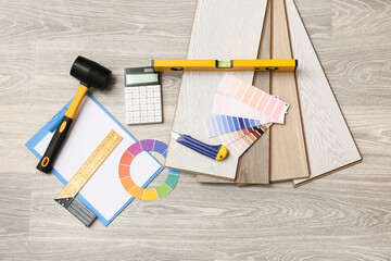 Tools, color palettes and laminate boards on floor