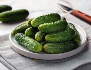 fresh mini cucumbers on white marble ready to cook and eat