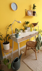 Interior of room with green plants and table