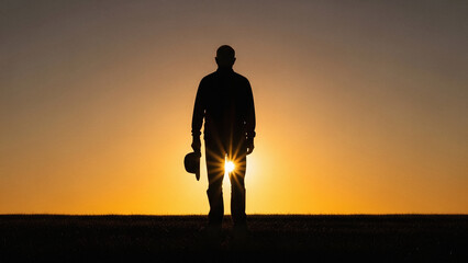Veterans Day concept with silhouette of senior man watching sunrise outside