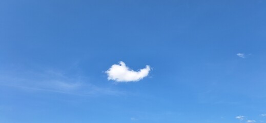 Beautiful blue sky with fluffy white clouds and copy space for background