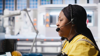 Helpline assistant troubleshoots errors in solar production systems, technician provides support for photovoltaic malfunctions or technical issues in renewable energy factory. Camera A.