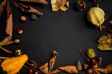 autumn leaves and spices on wooden background