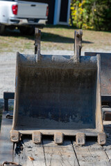An excavator bucket in a trailer