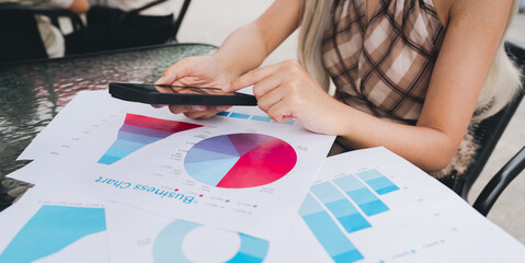 Business chart pie chart bar graph data analysis financial report businesswoman smartphone office desk marketing strategy statistics business document female hands casual clothing glass table