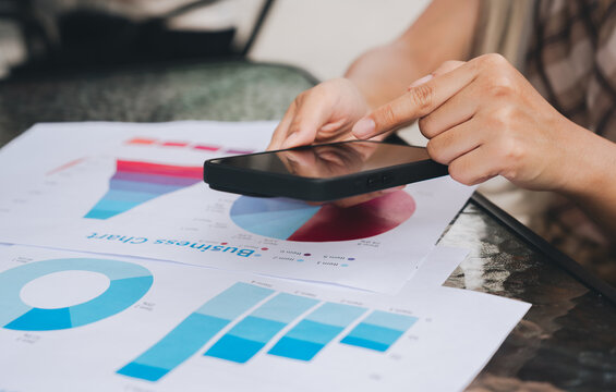 Business chart smartphone hand data analysis graph report office technology finance statistics person digital device communication modern work table paper presentation marketing business analytics