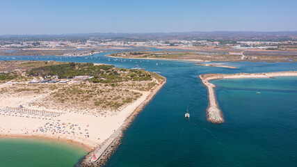 Aerial view of sandy beach with turquoise waters, boats navigating through channels, showcasing natural beauty and coastal serenity. Tavira Portugal Algarve