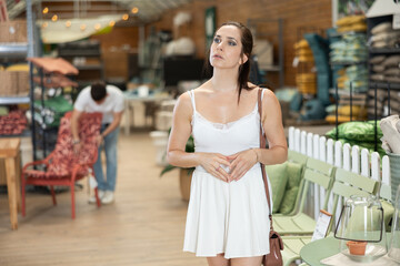 Female shopper choosing products in a gardening supply store