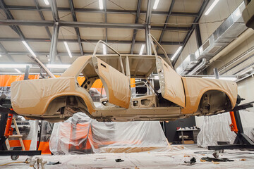 Professional anti corrosion undercoating treatment applied to hidden cavities of a car body. Long lasting metal protection and technical maintenance for extended vehicle lifespan.