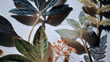 Exquisite paper botanical art: delicate, intricately cut leaves and dried flowers casting soft shadows on textured white paper, showcasing detailed craftsmanship.