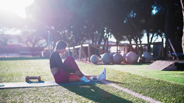 Peaceful woman calmly seated on earth during park break moment