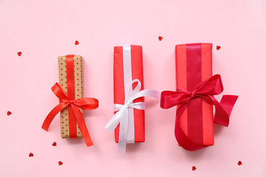 Set of gift boxes and heart-shaped sequins for Valentine's Day celebration on pink background - Powered by Adobe