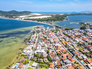 Aerial view of Conceicao lake with houses, dunes and forest