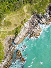 Aerial view of Bombinhas beaches with trails, rocks and forest