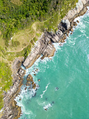 Aerial view of Bombinhas beaches with trails, rocks and forest