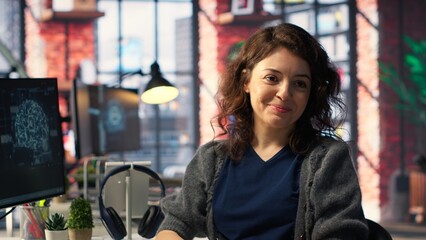 Female IT engineer doing maintenance on artificial intelligence systems, sitting at office desk. Young woman works as developer with cybernetics and algorithms for machine learning. Camera B.