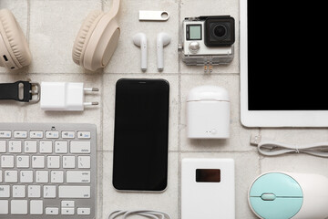 Composition with different modern gadgets on light tile background