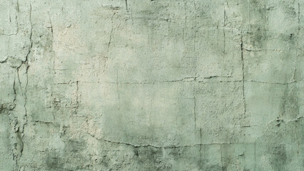 Obraz premium A distressed, light green concrete wall with prominent cracks and peeling paint, offering a worn and weathered textured background.