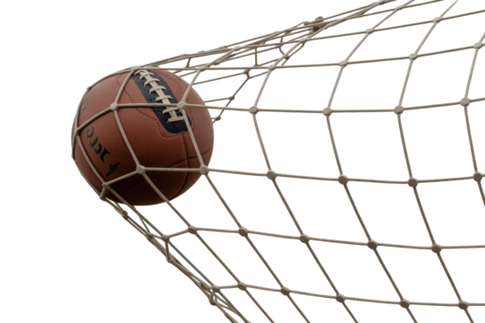 Vintage brown leather football captured mid-action within a white goal net, celebrating a decisive score. background removed