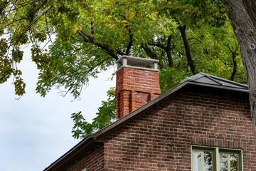 A damaged red brick chimney