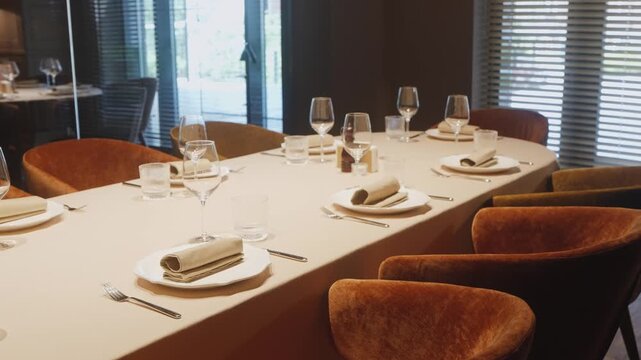 Chef tasting with refined details, Sophisticated setting featuring fine stemware and cozy chairs