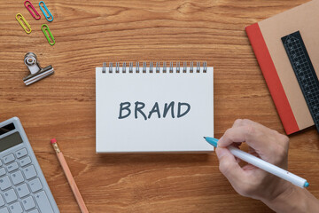 There is notebook with the word BRAND. It is as an eye-catching image.