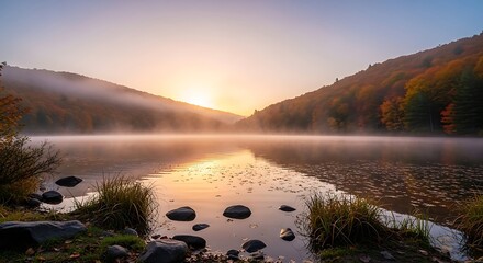 Calm lake reflecting the sunrise with fog and trees in the background landscape view