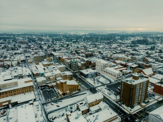 Cinematic aerial drone photos of a city covered in a fresh coat of snow. 