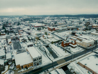 Cinematic aerial drone photos of a city covered in a fresh coat of snow. 
