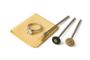 Diamond engagement ring and jewelry cleaning tools on transparent background