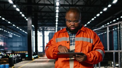 Factory worker communicates through walkie talkie near automation machinery, engineering skill and safe industrial operation. Teamwork required for productivity in industry plant. Camera B.