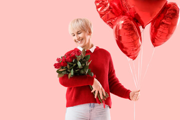 Happy mature woman with bouquet of roses and heart-shaped balloons on pink background. Valentine's...
