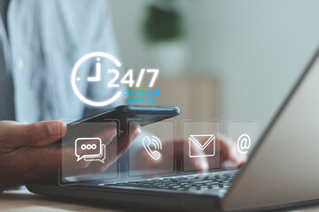 A person using a smartphone and laptop with virtual 24/7 customer service icons, representing nonstop support, digital communication, online assistance channels and modern service technology.