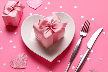 Beautiful table setting with gift boxes on pink background. Valentine's Day celebration