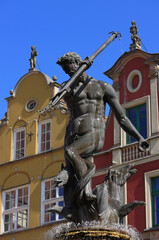 Fototapeta premium Gdansk, Poland. Neptune's Fountain, a historic fountain constructed between 1606 and 1633 in Flemish Mannerist-Rococo style, and is one of the most distinctive landmarks of the city. Hanseatic facades