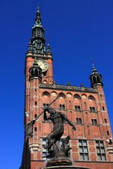 Naklejka premium Gdansk, Poland. The Main City Hall a fine example of the Gothic-Renaissance architecture. Neptune's Fountain in the foreground constructed between 1606 and 1633 in Flemish Mannerist-Rococo style. 