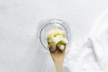 apple cheong in a glass jar on a white background, korean apple cheong in a transparent jar