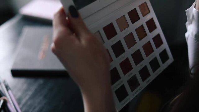 gorgeous lady applying eye make up on herself