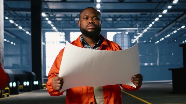 Employee walking in a facility with steel production plans in heavy industry manufacturing tasks, demonstrating development and strong workforce involvement in industrial environment. Camera B.