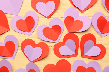Many paper hearts on yellow wooden background. Valentine's Day celebration