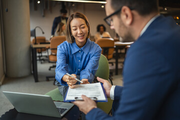 Businesswoman signing contract closing deal with partner