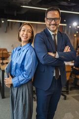 Diverse business partners standing back to back in office