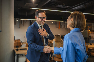 Smiling business colleagues enjoying a casual conversation in the office