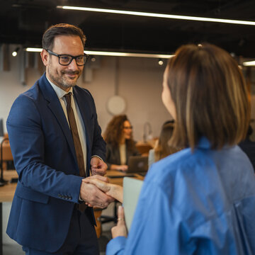 Smiling business colleagues enjoying a casual conversation in the office