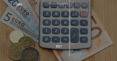 Displaying portable grey calculator resting on wooden desk, fanned Euro notes, coins, timeline